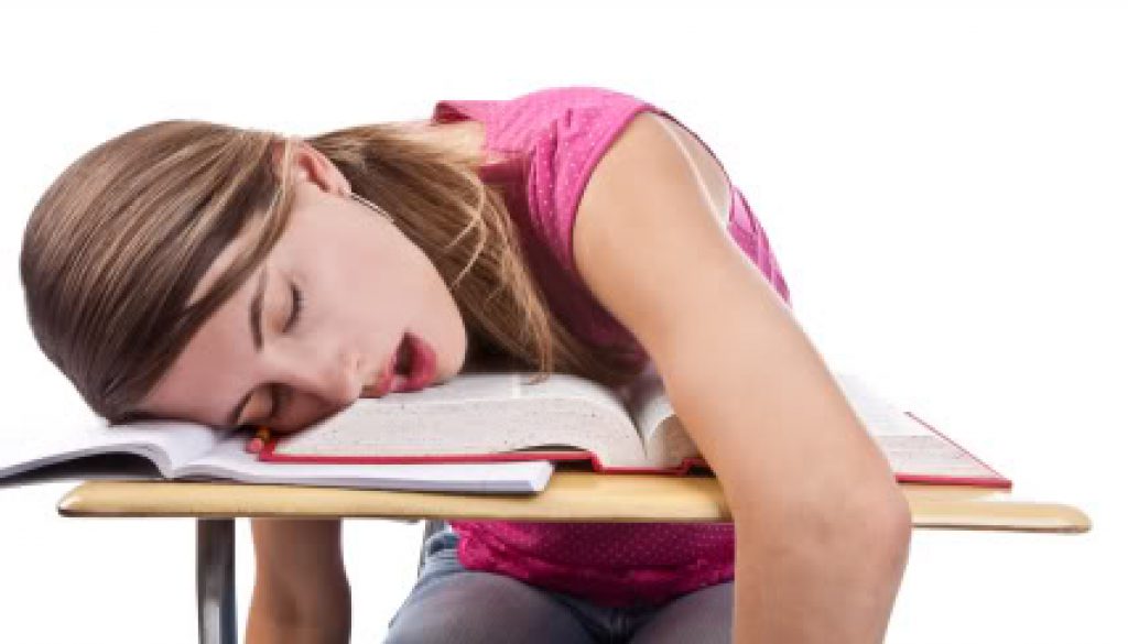 A student fast asleep on her school work.